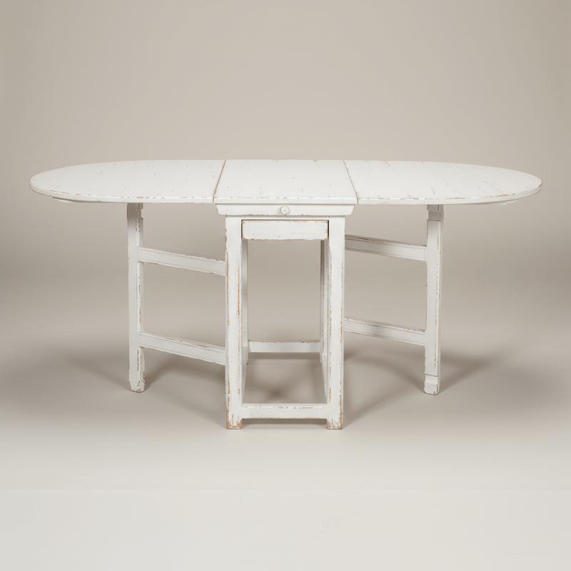 Whitewashed dropleaf dining table with distressed finish